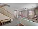 Spacious living room featuring carpet, neutral walls, stairs, and natural light at 6437 Boatbill St, North Las Vegas, NV 89084