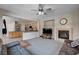 Open floor plan living room adjacent to the kitchen featuring a fireplace and large windows at 6437 Boatbill St, North Las Vegas, NV 89084