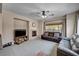 Living room featuring neutral carpet, fireplace, TV and a large window at 6437 Boatbill St, North Las Vegas, NV 89084