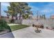 Backyard with concrete patio, small grass area, block wall and trees overhead at 6624 Old Oxford Ave, Las Vegas, NV 89108