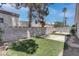 Lush backyard featuring well-kept synthetic grass, concrete patio, and block wall at 6624 Old Oxford Ave, Las Vegas, NV 89108