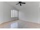 Bedroom featuring tile floors, a modern ceiling fan, and window with blinds at 6624 Old Oxford Ave, Las Vegas, NV 89108