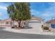 Charming single-story home featuring a two-car garage, desert landscaping, and a mature shade tree at 6624 Old Oxford Ave, Las Vegas, NV 89108