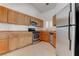 Traditional kitchen featuring wood cabinets, stainless steel appliances, and tile floors at 6624 Old Oxford Ave, Las Vegas, NV 89108