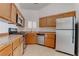 Traditional kitchen featuring wood cabinets, stainless steel appliances, and tile floors at 6624 Old Oxford Ave, Las Vegas, NV 89108