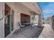 Covered patio featuring tile flooring, seating, and access to the backyard at 6624 Old Oxford Ave, Las Vegas, NV 89108