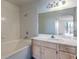 Bright bathroom with tiled shower-tub combination and a vanity with storage at 698 S Racetrack Rd # 1014, Henderson, NV 89015