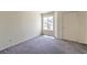 Bright bedroom with a window, closet, and neutral carpet, offering a comfortable and versatile living space at 698 S Racetrack Rd # 1014, Henderson, NV 89015