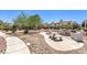 Relaxing common area with seating, barbeque, mature trees, and lush landscaping at 698 S Racetrack Rd # 1014, Henderson, NV 89015