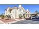 Charming condo complex with stucco walls, red tile roofs, and covered parking in a well-maintained community at 698 S Racetrack Rd # 1014, Henderson, NV 89015