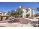 Inviting condo complex with well-manicured landscaping, covered seating, and charming architecture at 698 S Racetrack Rd # 1014, Henderson, NV 89015