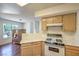 Kitchen featuring wood cabinets, white countertops, and a gas range at 698 S Racetrack Rd # 1014, Henderson, NV 89015