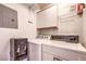 Functional laundry room with washer, dryer, shelving, and additional storage for laundry essentials and organization at 698 S Racetrack Rd # 1014, Henderson, NV 89015