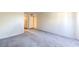 Open living room with neutral carpet and paint, ready for personal touches at 698 S Racetrack Rd # 1014, Henderson, NV 89015