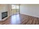 Living room features hardwood floors, fireplace, and sliding glass door to outdoor space at 698 S Racetrack Rd # 1014, Henderson, NV 89015