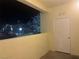 A quaint balcony with an attached closet offers a lovely view of the neighboring building and trees at nighttime at 698 S Racetrack Rd # 1411, Henderson, NV 89015