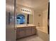 View of the bathroom with a tub, shower, sink, and mirror, with bedroom in background at 698 S Racetrack Rd # 1411, Henderson, NV 89015