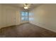 Carpeted bedroom features a ceiling fan and a window allowing natural light at 698 S Racetrack Rd # 1411, Henderson, NV 89015