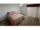 Bedroom with a neutral carpet, red curtain, queen bed, and a ceiling fan at 698 S Racetrack Rd # 1411, Henderson, NV 89015