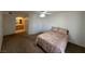 Open bedroom with view into bathroom, carpeted floors, queen bed, and ceiling fan at 698 S Racetrack Rd # 1411, Henderson, NV 89015
