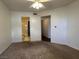 Carpeted bedroom that leads to a bathroom featuring a shower and toilet at 698 S Racetrack Rd # 1411, Henderson, NV 89015