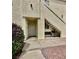 A charming condo entrance with a cozy bench, a tidy garden, and a stucco facade at 698 S Racetrack Rd # 1411, Henderson, NV 89015