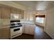 Functional kitchen featuring linoleum countertops, white appliances and a window view at 698 S Racetrack Rd # 1411, Henderson, NV 89015