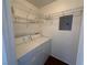 Bright laundry room with a washer and dryer, shelving, and hardwood floor at 698 S Racetrack Rd # 1411, Henderson, NV 89015