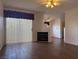 Spacious living room featuring wood-look tile flooring, fireplace, and abundant natural light at 698 S Racetrack Rd # 1411, Henderson, NV 89015