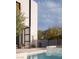 Modern backyard featuring a beautiful pool, outdoor seating area, and lush greenery at 7030 Schirlls St, Las Vegas, NV 89118