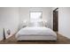 Cozy bedroom with hardwood floors, minimalist decor, and a peaceful ambiance at 7030 Schirlls St, Las Vegas, NV 89118
