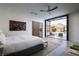 Serene primary bedroom featuring a sliding barn door and a view of the backyard pool at 7030 Schirlls St, Las Vegas, NV 89118