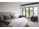 Bright bedroom with serene decor, featuring large windows offering natural light and a patio at 7030 Schirlls St, Las Vegas, NV 89118