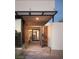 Modern entryway featuring wood accents and a sleek, covered porch at 7030 Schirlls St, Las Vegas, NV 89118