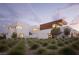 Modern home with a sleek design and natural landscaping at 7030 Schirlls St, Las Vegas, NV 89118