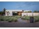 Contemporary home with modern landscape and stone pathway at 7030 Schirlls St, Las Vegas, NV 89118