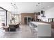 Spacious open-concept kitchen and dining area with waterfall island and modern pendant lighting at 7030 Schirlls St, Las Vegas, NV 89118