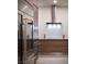 Sleek modern kitchen featuring stainless steel appliances and minimalist wood cabinetry at 7030 Schirlls St, Las Vegas, NV 89118