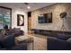 Inviting living room with a stone accent wall, fireplace, and stylish decor at 7030 Schirlls St, Las Vegas, NV 89118