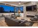 Modern living room with stone fireplace and stunning views, perfect for relaxing and entertaining at 7030 Schirlls St, Las Vegas, NV 89118