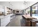 Open-concept living space with modern kitchen, dining, and living area at 7030 Schirlls St, Las Vegas, NV 89118