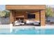 Stunning poolside cabana with outdoor seating, a TV, and views of the refreshing pool at 7030 Schirlls St, Las Vegas, NV 89118