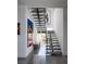 Modern staircase with floating steps and artistic wall decor, offering a unique architectural design at 7030 Schirlls St, Las Vegas, NV 89118