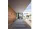 Modern walkway leading to a contemporary home with wood accents at 7030 Schirlls St, Las Vegas, NV 89118