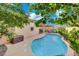 Backyard featuring a private pool with seating and verdant trees perfect for relaxation and entertainment at 708 Kibbey St, Las Vegas, NV 89178