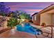 A picturesque pool area is set against a backdrop of vibrant landscaping and a tranquil ambiance at twilight at 708 Kibbey St, Las Vegas, NV 89178