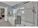 Modern bathroom boasts a glass shower enclosure next to a soaking tub, and a window with outside views at 708 Kibbey St, Las Vegas, NV 89178