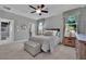 Comfortable primary bedroom features a ceiling fan and windows dressed with patterned valances and curtains at 708 Kibbey St, Las Vegas, NV 89178