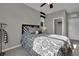 Bedroom showcasing a patterned bed, ceiling fan, and a closet at 708 Kibbey St, Las Vegas, NV 89178