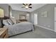 Serene primary bedroom with neutral carpet, ceiling fan, and windows dressed with patterned valances and curtains at 708 Kibbey St, Las Vegas, NV 89178